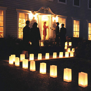 paper luminaries along path leading up to party entrance
